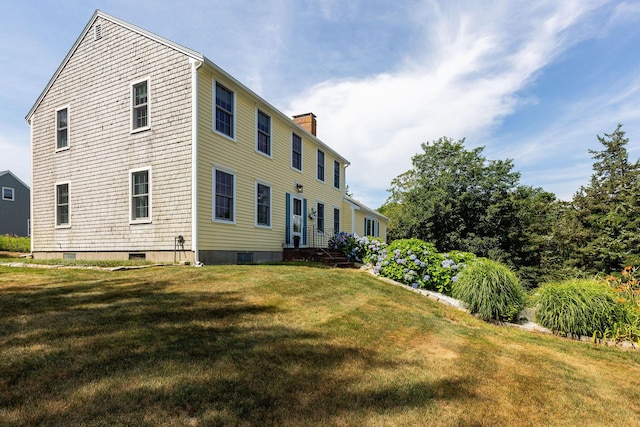 10 Briarfield Rd, South Dennis, MA 02660 - back of house with a chimney and a lawn