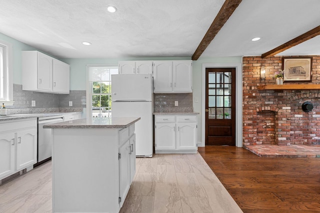 10 Briarfield Rd, South Dennis, MA 02660 - kitchen with freestanding refrigerator, dishwasher, white cabinets, decorative backsplash, and beamed ceiling