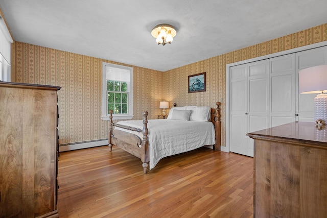 10 Briarfield Rd, South Dennis, MA 02660 - bedroom with wallpapered walls, a baseboard heating unit, and wood finished floors