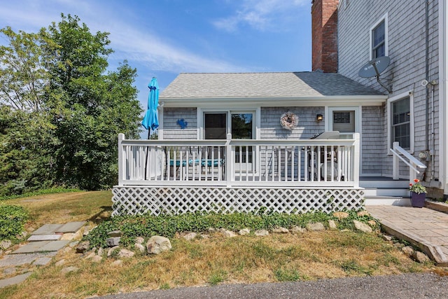 10 Briarfield Rd, South Dennis, MA 02660 - view of front of property with roof with shingles, a chimney, a front lawn, and a deck
