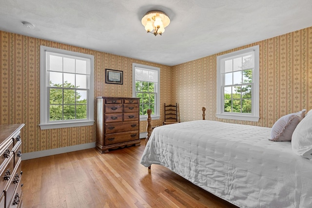 10 Briarfield Rd, South Dennis, MA 02660 - bedroom with wallpapered walls and light wood finished floors