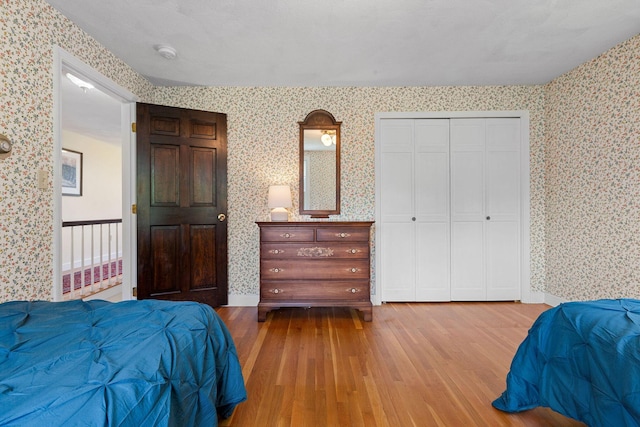 10 Briarfield Rd, South Dennis, MA 02660 - bedroom with wallpapered walls, wood finished floors, and a closet
