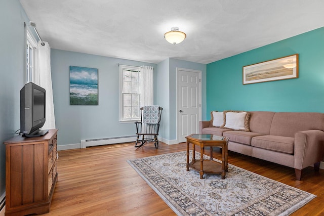 10 Briarfield Rd, South Dennis, MA 02660 - living area featuring a baseboard heating unit and light wood-style floors