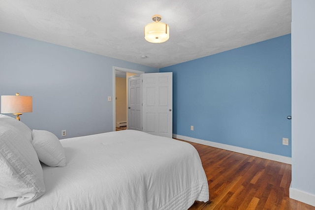 10 Briarfield Rd, South Dennis, MA 02660 - bedroom with a baseboard heating unit and wood finished floors
