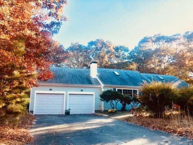 5 Greyhampton Rd, West Yarmouth, MA 02673 - ranch-style house featuring an attached garage, a chimney, and driveway