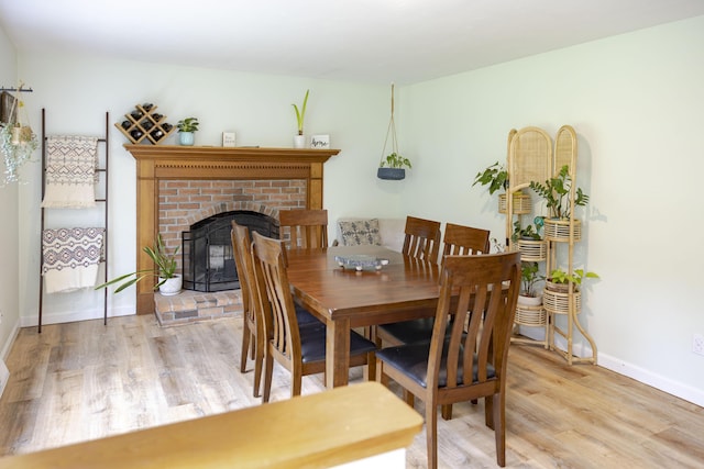 68 Harlow Rd, Sandwich, MA 02563 - dining space featuring light wood-type flooring and a fireplace