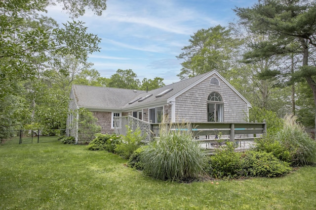 68 Harlow Rd, Sandwich, MA 02563 - back of property with a lawn, a deck, and a shingled roof
