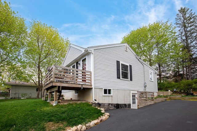 16 Town Neck Rd, Sandwich, MA 02563 - view of home's exterior with a yard, a wooden deck, and aphalt driveway
