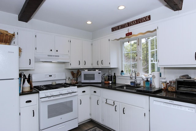 70 Deerfield Ln, Eastham, MA 02642 - kitchen featuring white appliances, under cabinet range hood, a sink, dark countertops, and recessed lighting