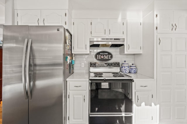 kitchen featuring electric range, decorative backsplash, freestanding refrigerator, under cabinet range hood, and white cabinetry