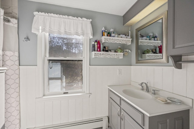 bathroom with a baseboard radiator, vanity, and wainscoting