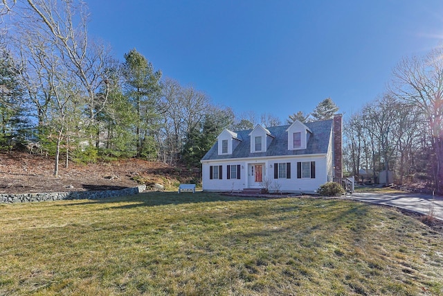 cape cod home featuring a front lawn