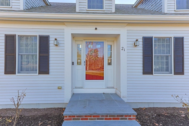 entrance to property with roof with shingles