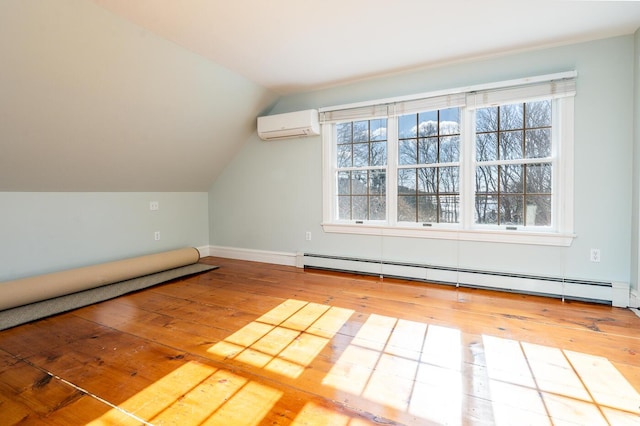 223 Main St, Wellfleet, MA 02667 - additional living space with a baseboard radiator, a wall unit AC, wood-type flooring, plenty of natural light, and lofted ceiling