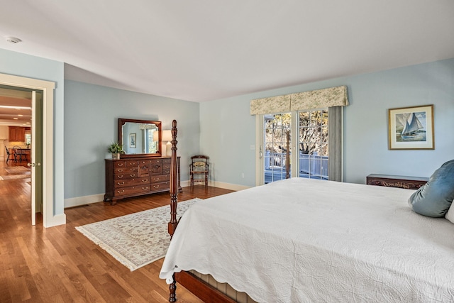 bedroom with hardwood / wood-style flooring and access to outside