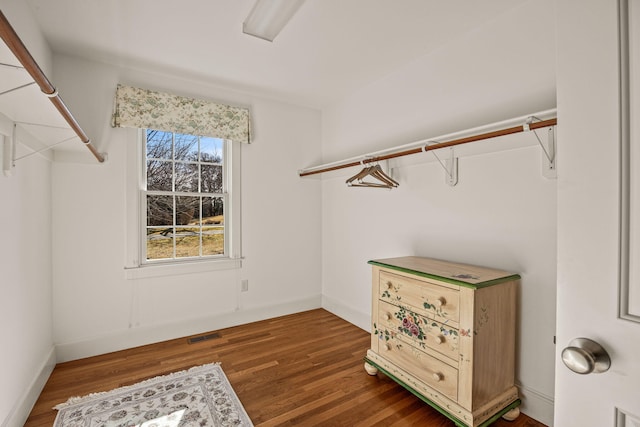 walk in closet featuring dark wood-type flooring