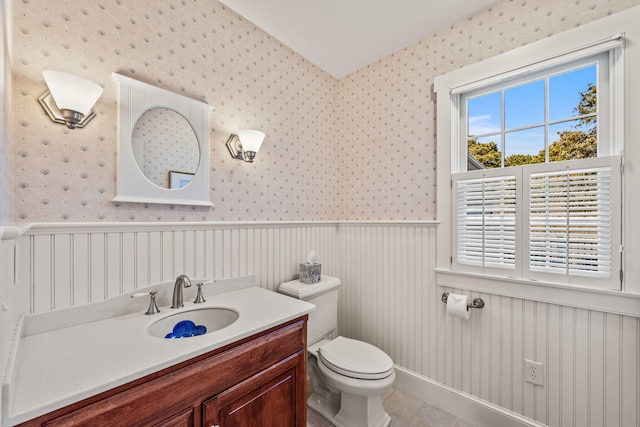 bathroom featuring tile patterned floors, vanity, and toilet