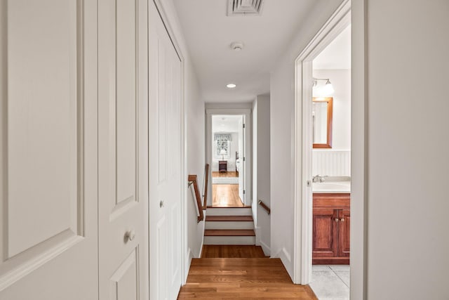 hall with sink and light hardwood / wood-style floors