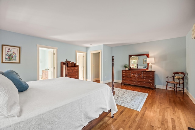 bedroom featuring hardwood / wood-style flooring and ensuite bathroom