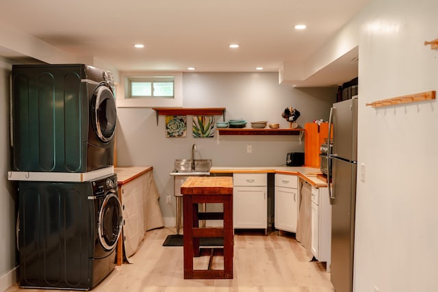 208 Irenes Way, Tisbury, MA 02568 - washroom with stacked washer and clothes dryer, recessed lighting, and light wood-style floors