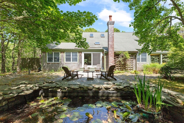 13 Try Works Rd, Truro, MA 02666 - rear view of house featuring a patio, roof with shingles, and a small pond