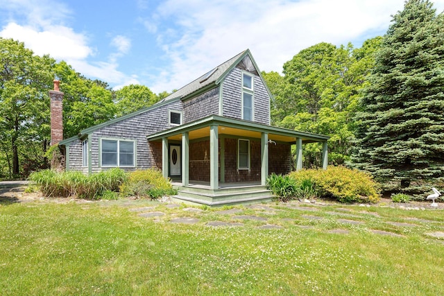 13 Try Works Rd, Truro, MA 02666 - view of front facade featuring a porch, a front yard, and a chimney