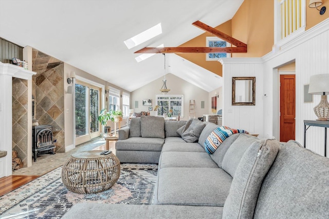 13 Try Works Rd, Truro, MA 02666 - living area featuring a skylight, a wood stove, wood finished floors, and high vaulted ceiling