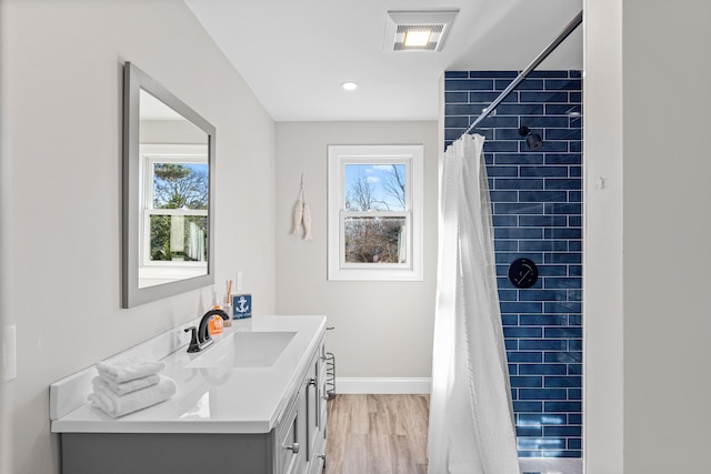 bathroom with a shower with curtain, hardwood / wood-style floors, and vanity