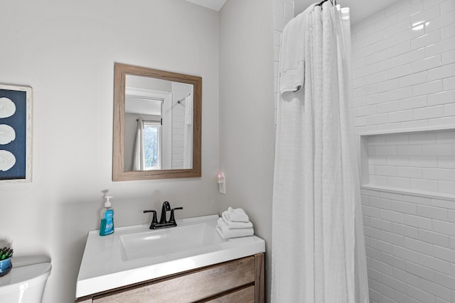 bathroom featuring vanity, toilet, and a shower with curtain