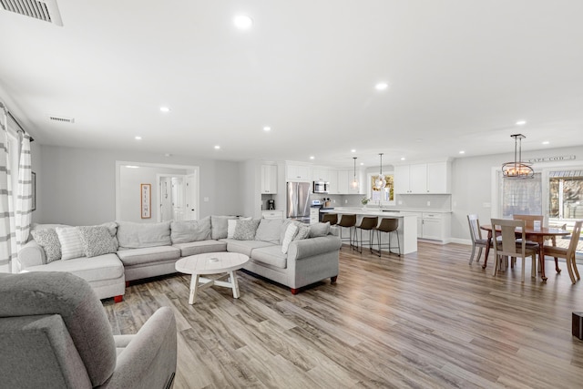 living room with light hardwood / wood-style flooring