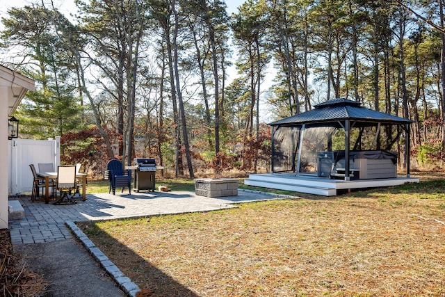 view of yard with a fire pit, a patio area, a gazebo, and a hot tub