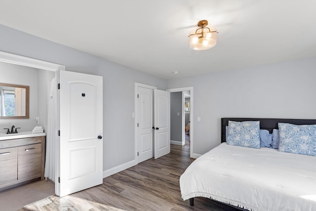 bedroom featuring sink and hardwood / wood-style floors