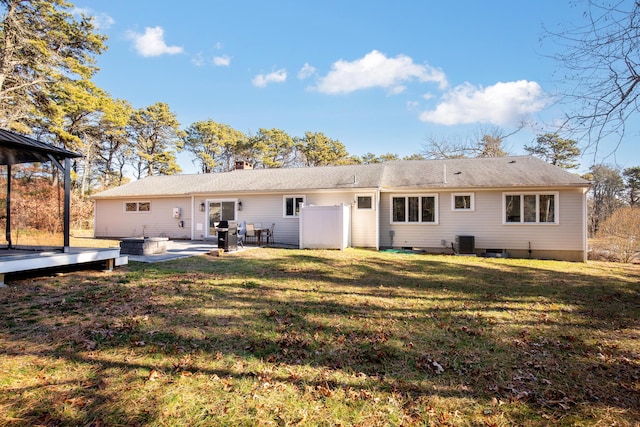 back of house with central air condition unit, a yard, and a patio