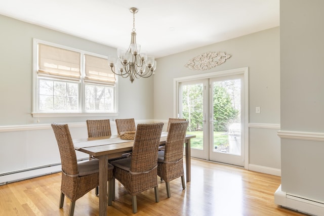 331 Riverview Dr, Chatham, MA 02633 - dining space with a baseboard radiator, a chandelier, light wood-style flooring, and baseboards