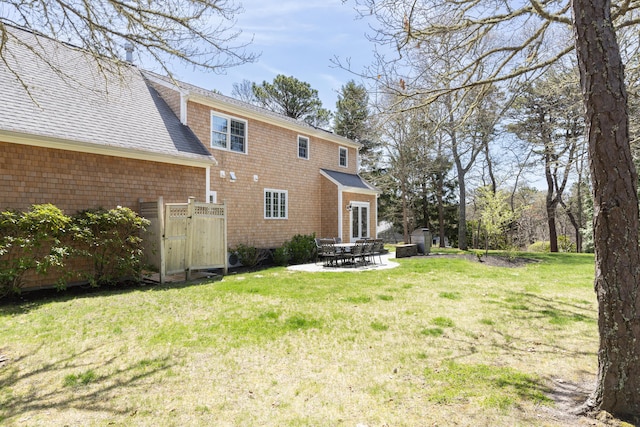 331 Riverview Dr, Chatham, MA 02633 - back of property with a lawn, a patio, a shingled roof, and a gate