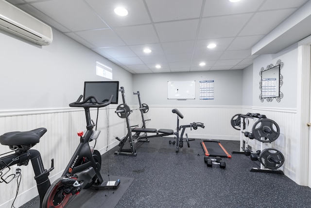 331 Riverview Dr, Chatham, MA 02633 - exercise area with a wall mounted air conditioner, a wainscoted wall, recessed lighting, and a paneled ceiling