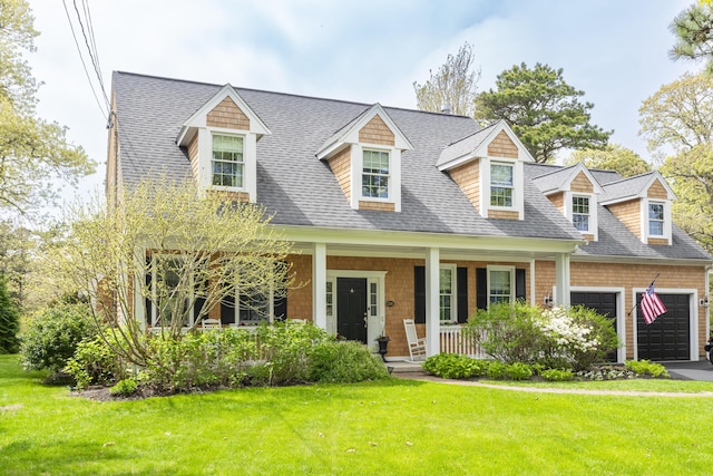 331 Riverview Dr, Chatham, MA 02633 - new england style home with covered porch, a front yard, an attached garage, roof with shingles, and asphalt driveway