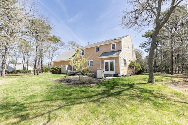 331 Riverview Dr, Chatham, MA 02633 - back of property with french doors, a lawn, and entry steps