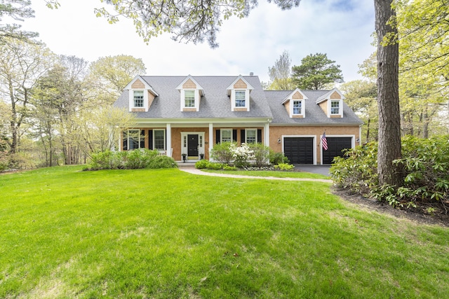 331 Riverview Dr, Chatham, MA 02633 - cape cod home with driveway, a porch, a front yard, brick siding, and a garage