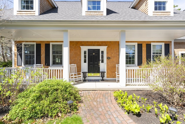 331 Riverview Dr, Chatham, MA 02633 - view of exterior entry featuring a porch and roof with shingles