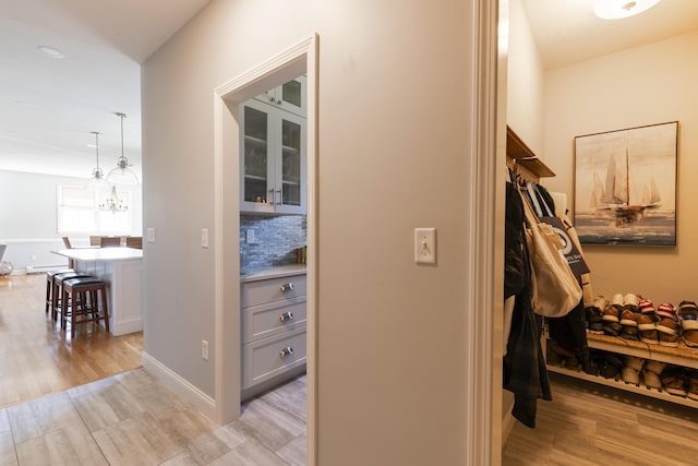 331 Riverview Dr, Chatham, MA 02633 - hall with light wood-type flooring and a chandelier