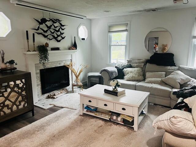 157 Mockingbird Ln, Marstons Mills, MA 02648 - living area featuring a tiled fireplace and wood finished floors
