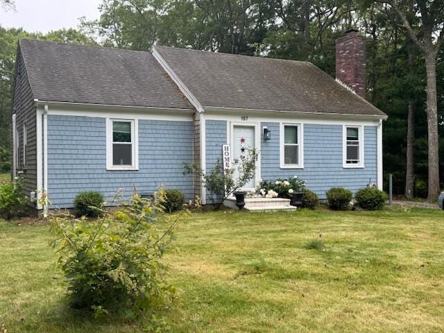 157 Mockingbird Ln, Marstons Mills, MA 02648 - view of front of house with a front yard, a chimney, and a shingled roof