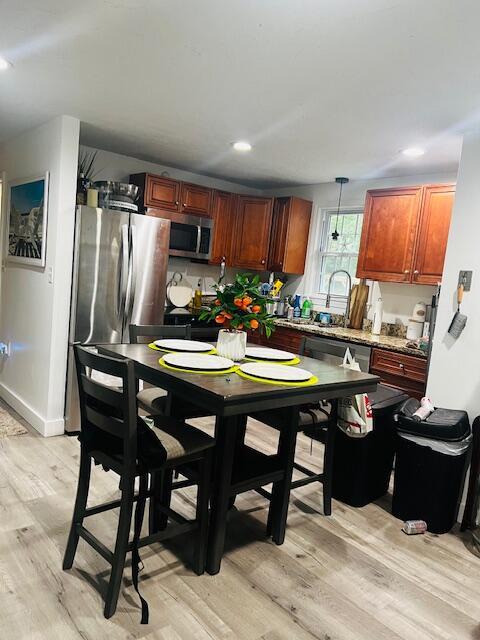 157 Mockingbird Ln, Marstons Mills, MA 02648 - kitchen with appliances with stainless steel finishes, light wood-style flooring, recessed lighting, light countertops, and decorative light fixtures