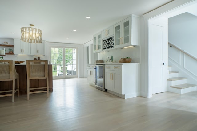 kitchen with recessed lighting, white cabinetry, and light wood-style floors