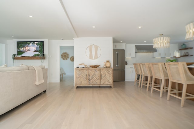 living room with recessed lighting and light wood finished floors