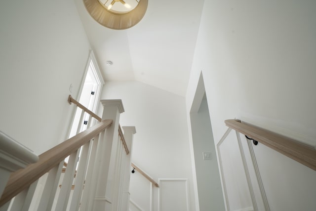 staircase featuring vaulted ceiling