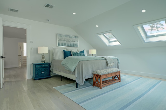 bedroom with light wood-style floors, recessed lighting, visible vents, and lofted ceiling with skylight