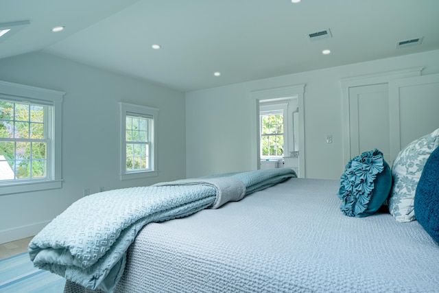 bedroom featuring visible vents and multiple windows