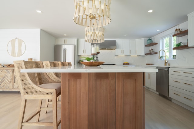 kitchen featuring open shelves, stainless steel appliances, light countertops, decorative backsplash, and a kitchen island